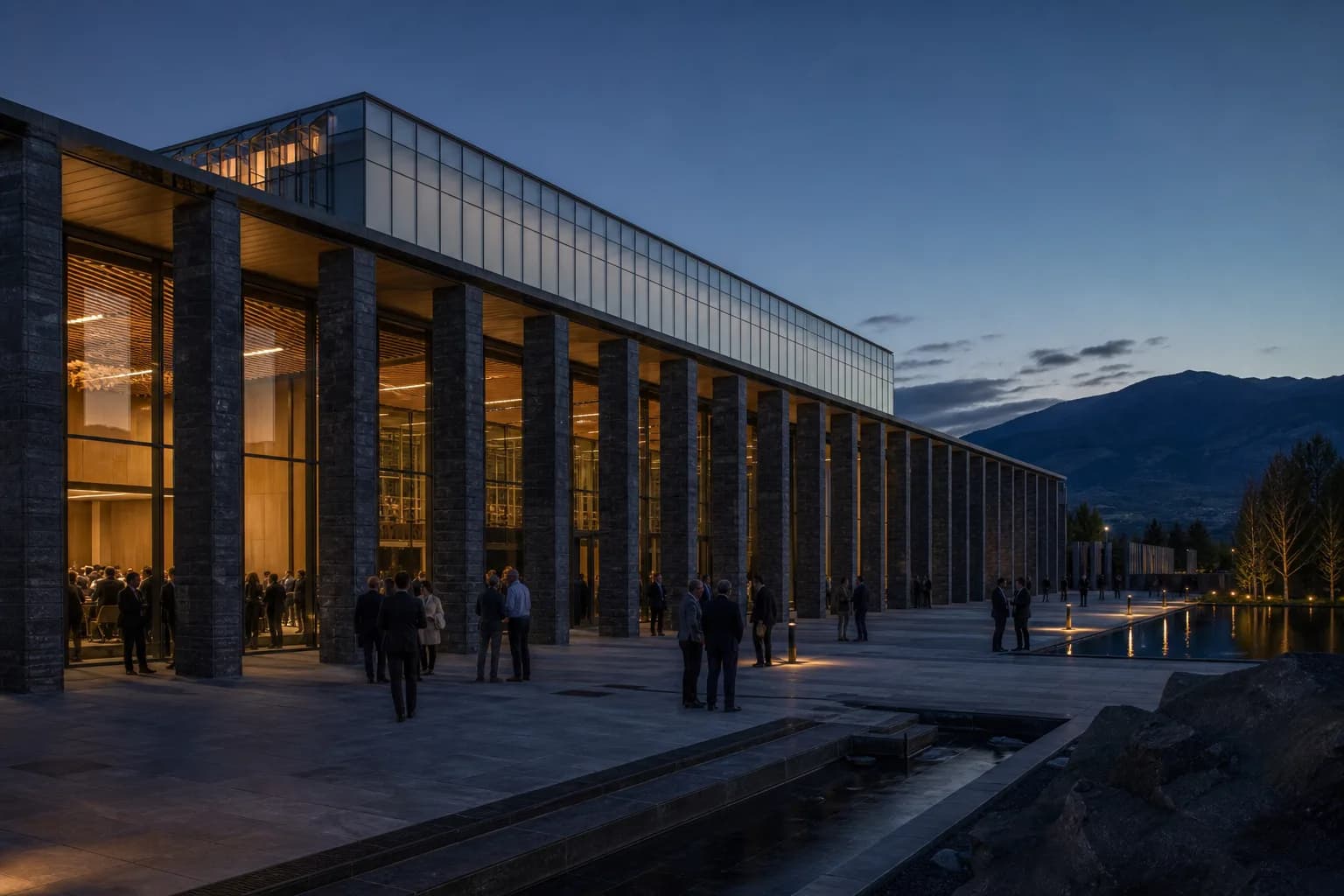 Scientific conference center with a stone plaza at blue hour.